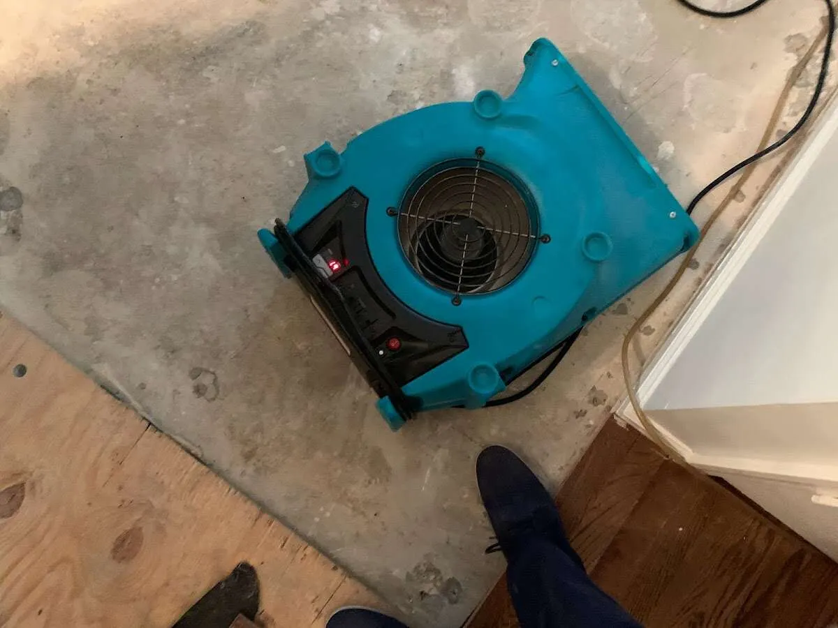 Air mover drying subfloor during Leak Detection & Repair in Miramar Beach